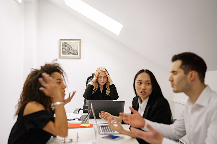 Konflikt i arbetsgrupp som sitter vid ett bord